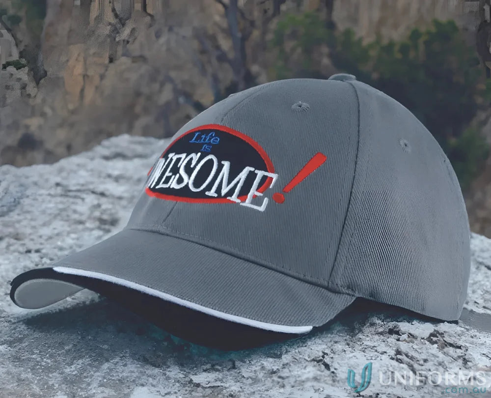 Gray baseball cap made of brushed heavy sports twill with contour trim and indented peak