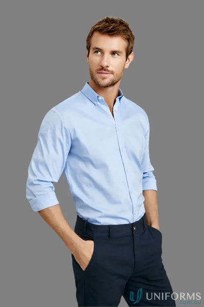 Man in light blue camden cotton rich long sleeve shirt and dark pants