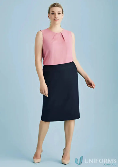 Woman in pink sleeveless top and dark blue skirt for work environments and professional image