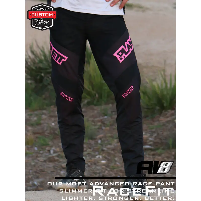 Black motocross pants with pink accents.