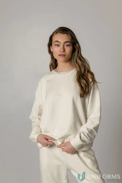 Woman in matching cream-colored Archie Crew Sweat in unbrushed French terry fabric