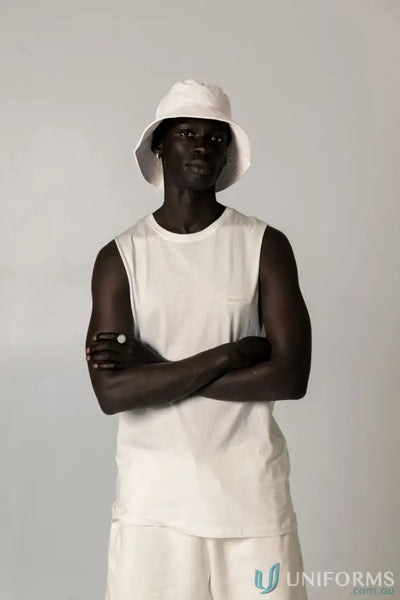 Man in white bucket hat wearing Cotton Tank Top with raw cut sleeve and nameless chest embroidery