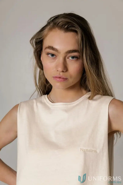 Sleeveless cream-colored Cotton Tank Top with raw cut sleeve and nameless chest embroidery