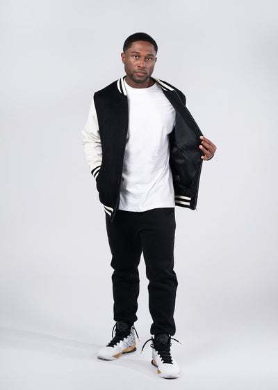 Black and white varsity wool blend jacket with ribbed collar sleeve stripes and zipper front perfect for workwear uniforms