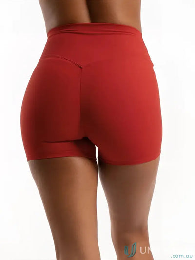Red high-waisted invicible scrunch cherry shorts with smooth fabric perfect for comfortable work uniforms and workwear