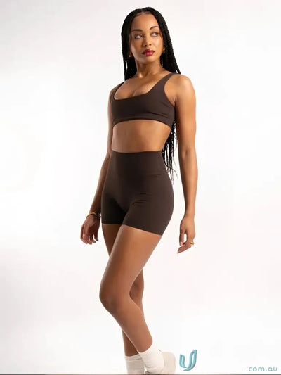 A sleek brown two-piece workout set with cropped top and high-waisted shorts perfect for workwear uniforms