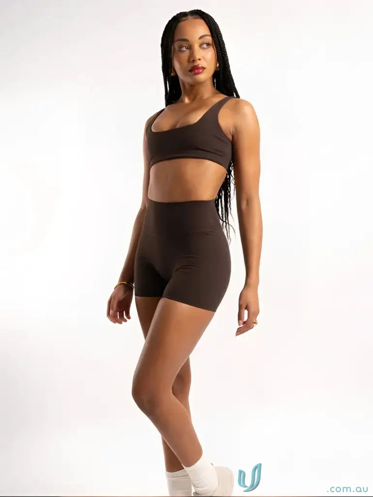 A sleek brown two-piece workout set with cropped top and high-waisted shorts perfect for workwear uniforms