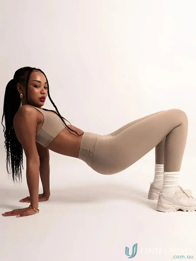 Beige seamless crop top and form-fitting leggings in the invicible scrunch latte leggings set ideal for work uniforms