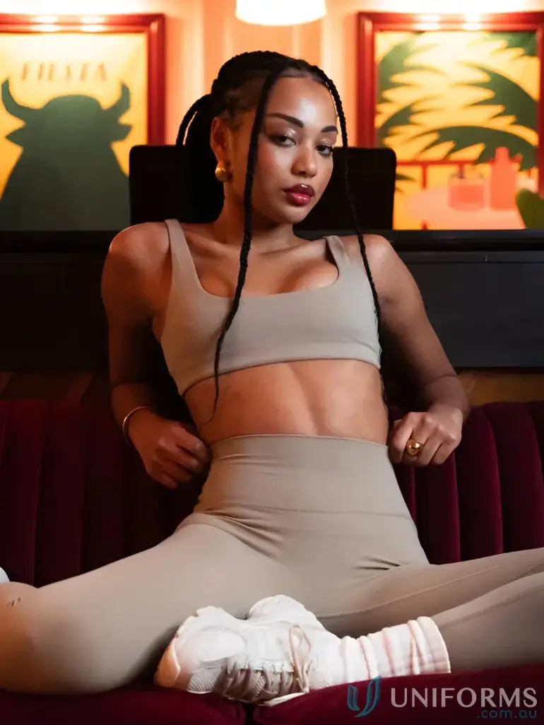 Beige athletic two-piece set with cropped top and high-waisted invicible scrunch latte leggings great for workwear uniforms