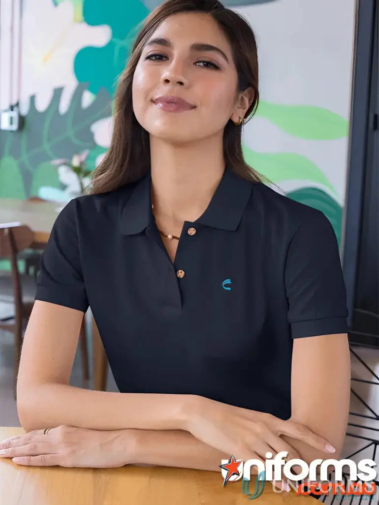Women wearing IOP EMB Ladies Polo in modern fit uniforms with blue logo and buttons