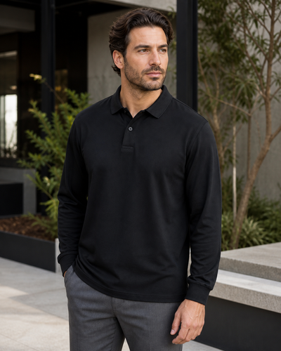 Male model wearing black JB's Podium Long Sleeve Stretch Polo