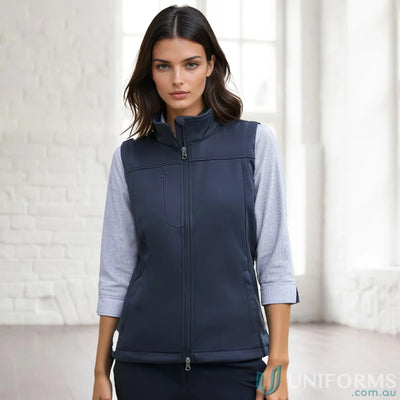 A womans navy blue sleeveless vest with a full zipper closure and a stand-up collar.
