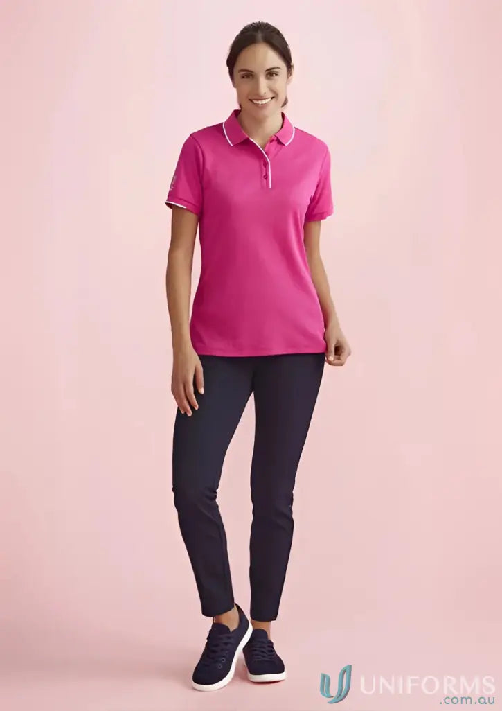 Bizcare women’s pink NBCF Ladies Pink short sleeve polo shirt on woman in dark pants