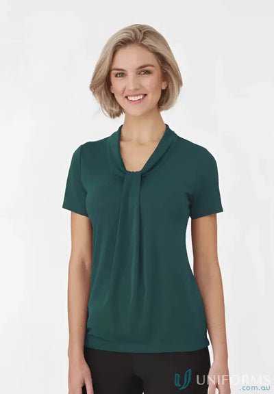 Woman in a green Pippa Ladies SS Top with soft draped neckline and comfortable fit