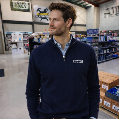Navy blue Plumbers Choice half zip pullover with white logo, workwear uniforms