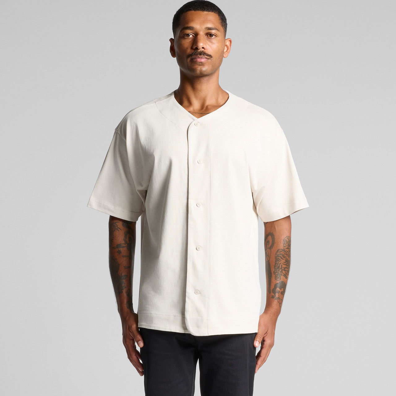 Cream-colored baseball jersey with short sleeves and button-down front.