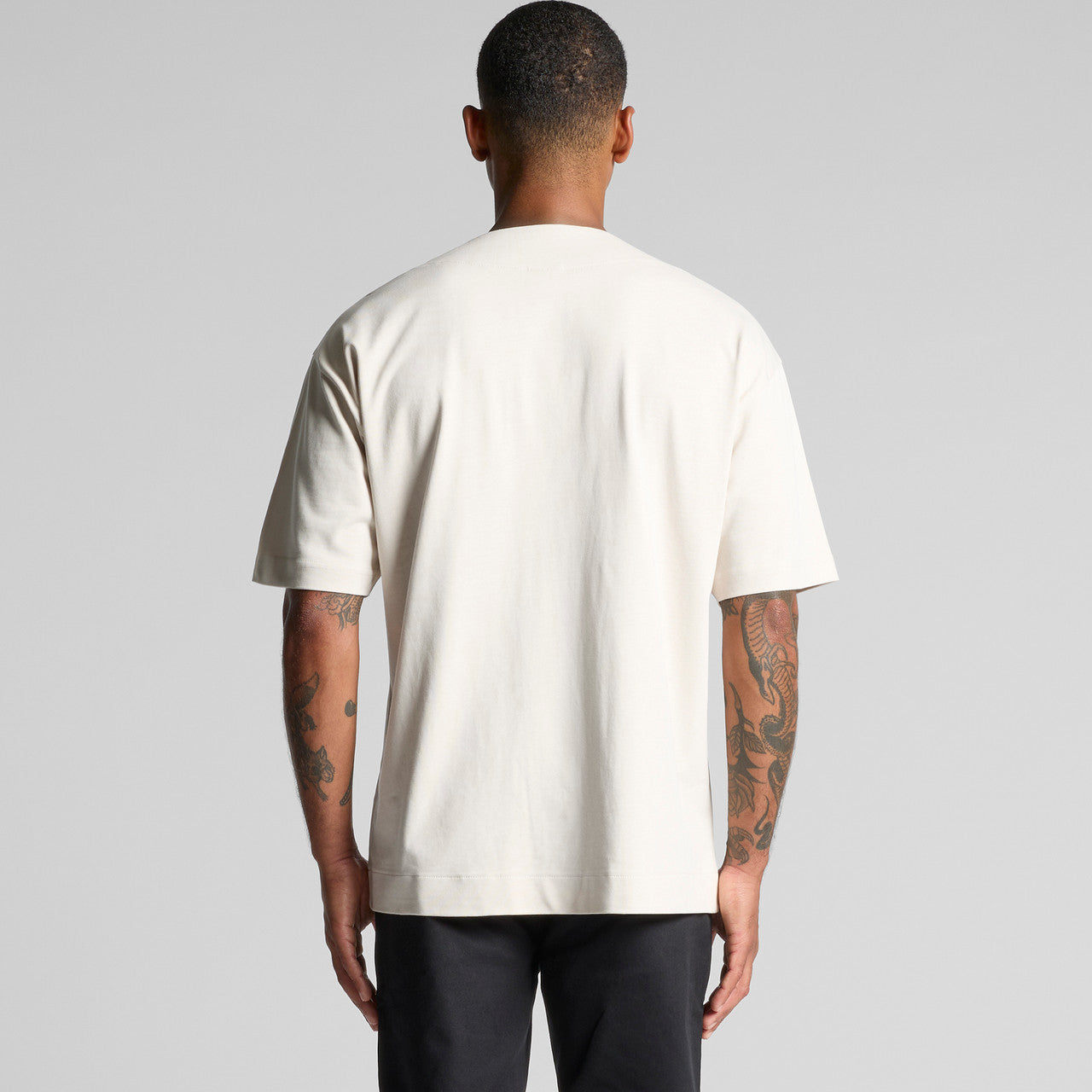 Cream-colored oversized t-shirt with a pocket and short sleeves.