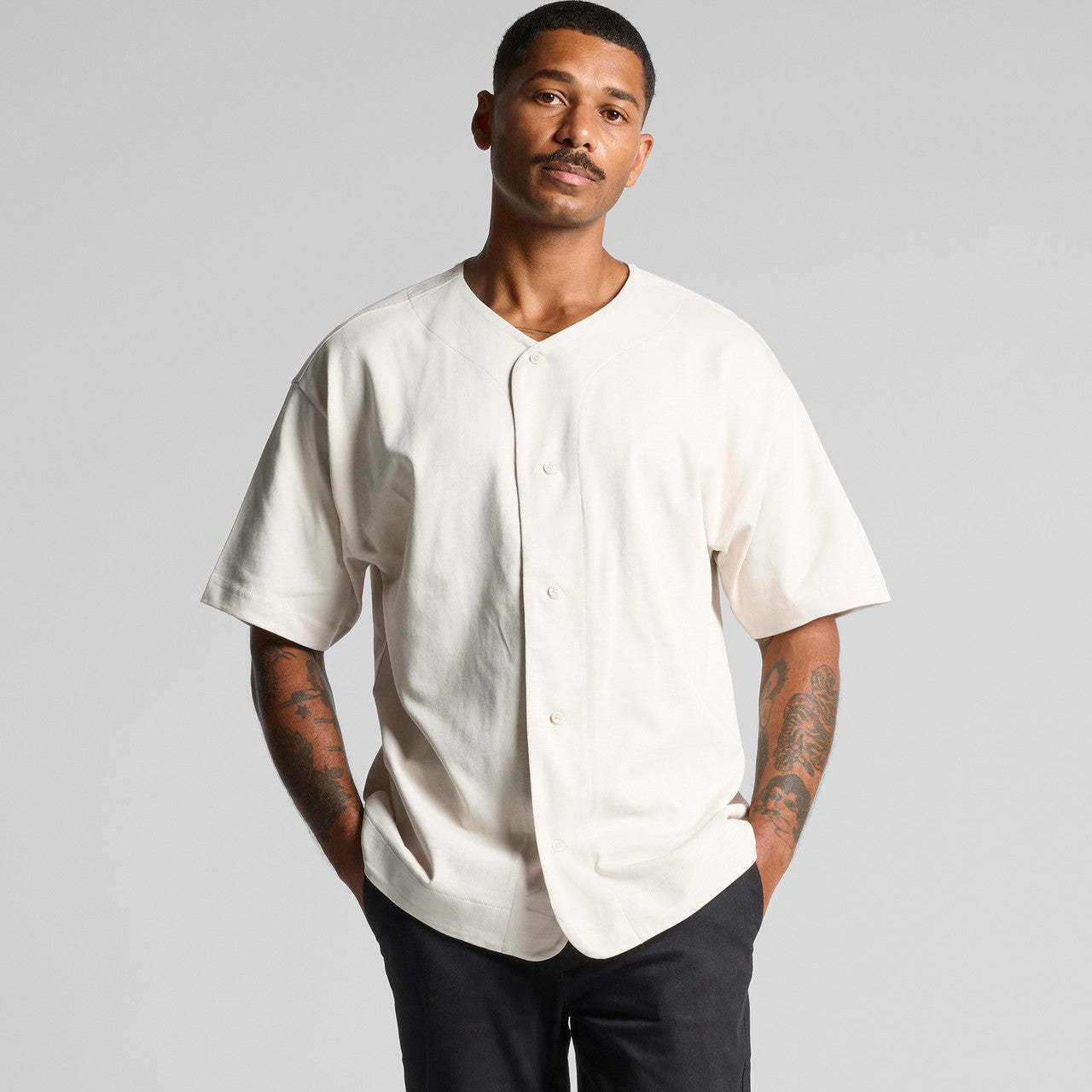 Cream baseball jersey with button-down front and short sleeves.