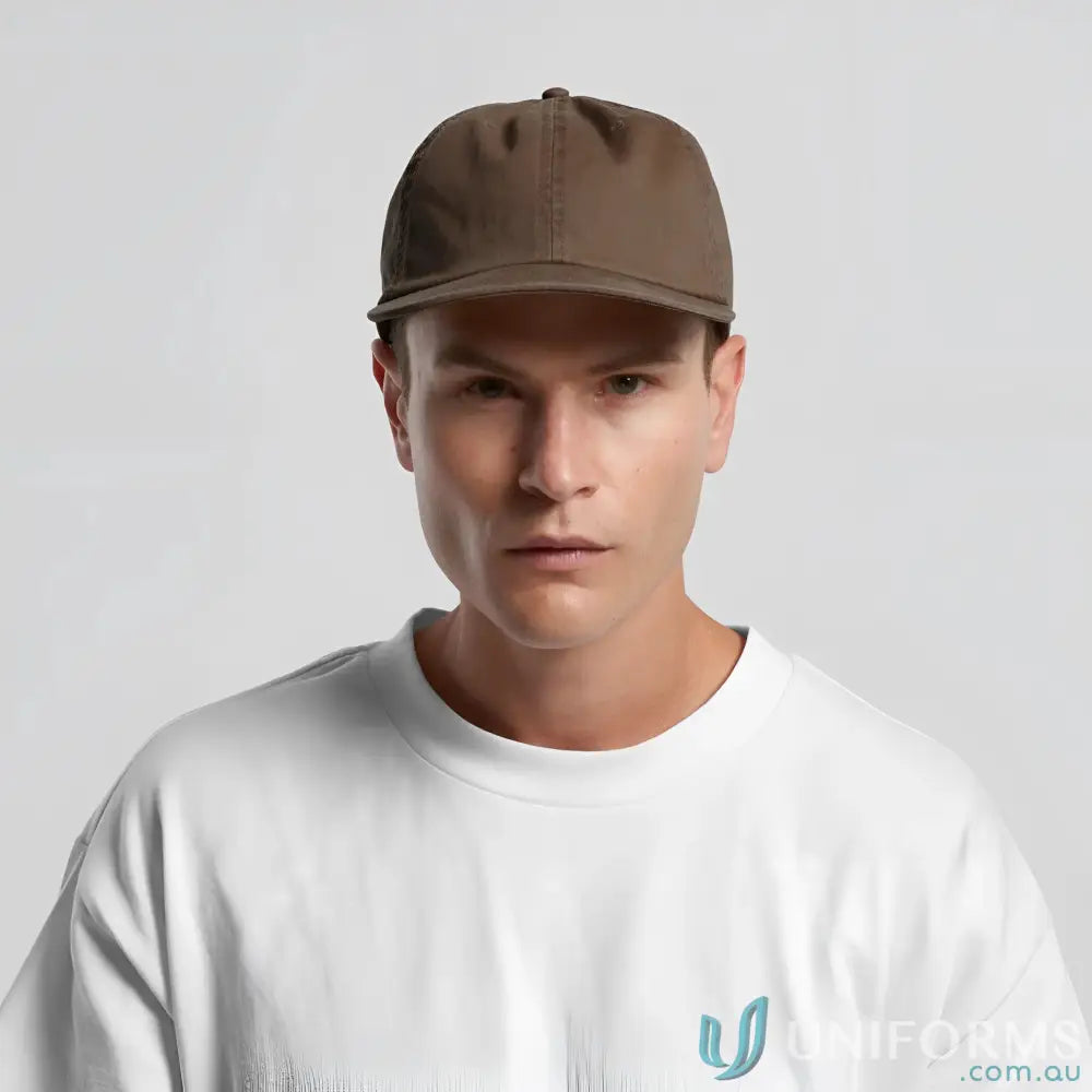 Man wearing a plain brown cotton cap with flat peak and metal clasp, tonal under-peak lining