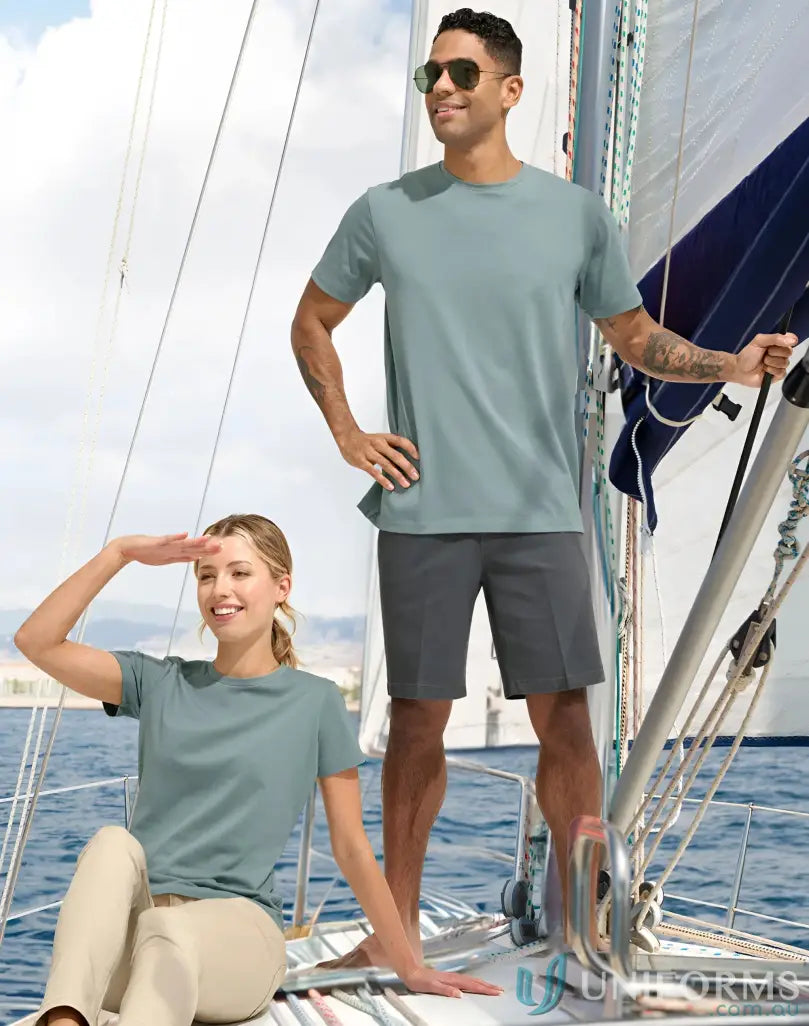 Two people in matching sailing t-shirts on a sailboat wearing the spirit premium tee