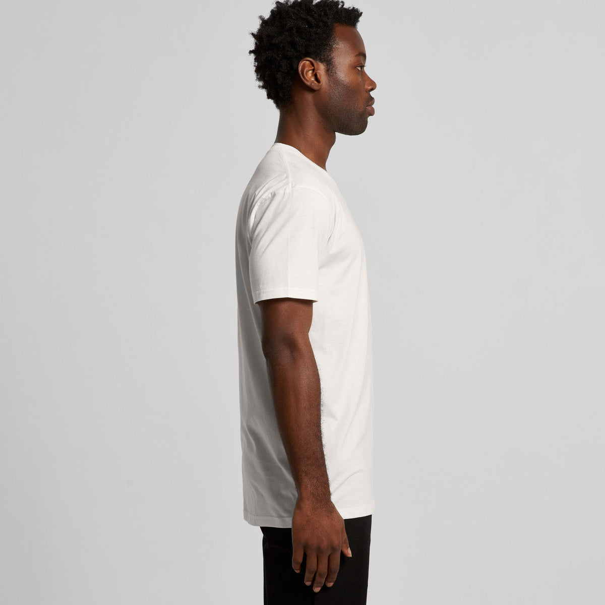 White crew neck t-shirt with black pants and a simple design.