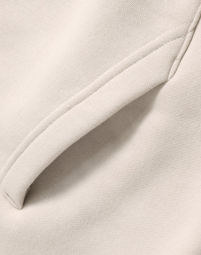 Cream-colored premium oversized bone hoodie with soft textured fabric and neat seams perfect for work uniforms and workwear