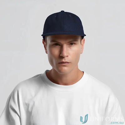 Man in navy blue flat-brimmed cap with adjustable metal clasp and tonal under-peak lining