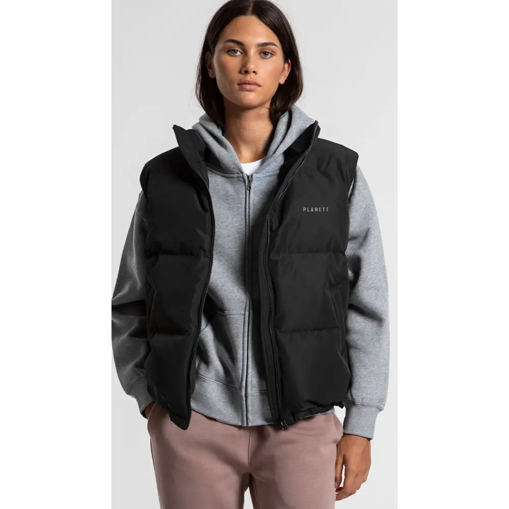 Black sarah puffer vest with hood and front zipper layered over gray hoodie perfect for workwear uniforms