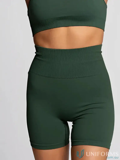 Dark green high-waisted athletic shorts with ribbed waistband and seamless design.