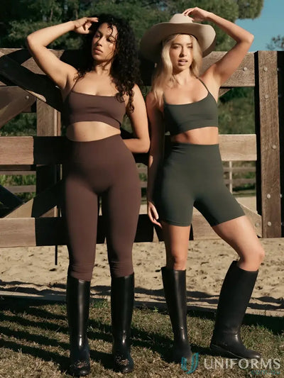 Two women wearing seamless invisible scrunch espresso leggings in brown and olive green workwear crop tops and boots