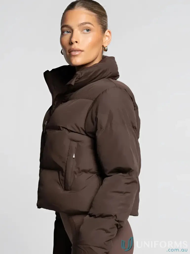 A sleek dark brown short puffer jacket with high collar and quilted design ideal for workwear uniforms