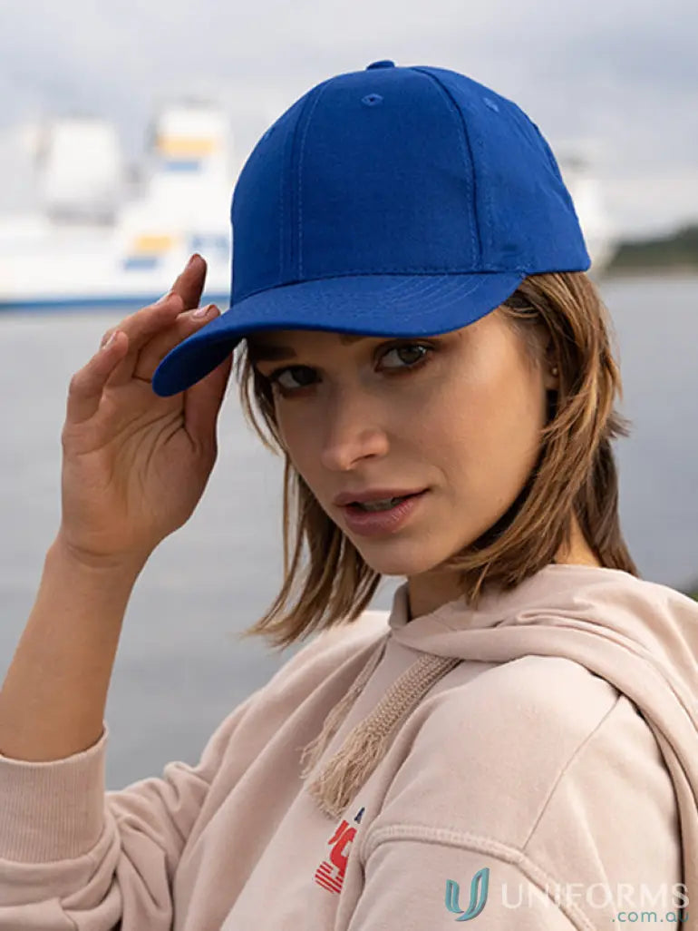 Young woman wearing a plain blue SnapBack Cap with imprint, high stock range