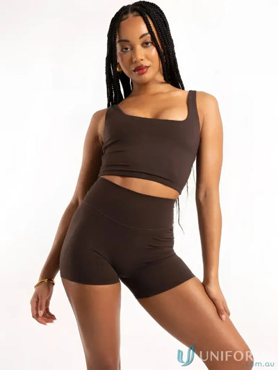 Brown two-piece athletic set with square neck chocolate tank and high-waisted shorts made from stretchy fabric ideal for workwear uniform