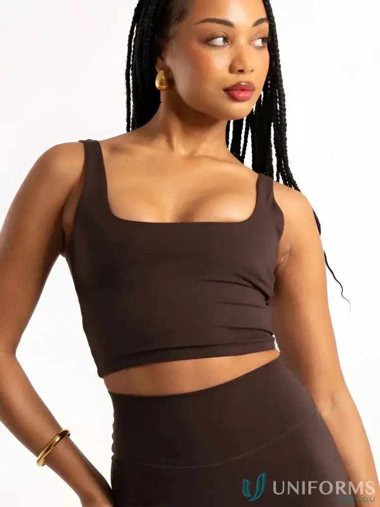 A sleek dark brown cropped tank top with square neckline and thin straps perfect for stylish work uniforms or workwear