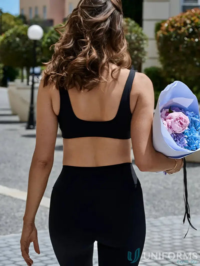 Black athletic crop top with square back cutout and sleek fit perfect for sporty uniforms and work uniforms