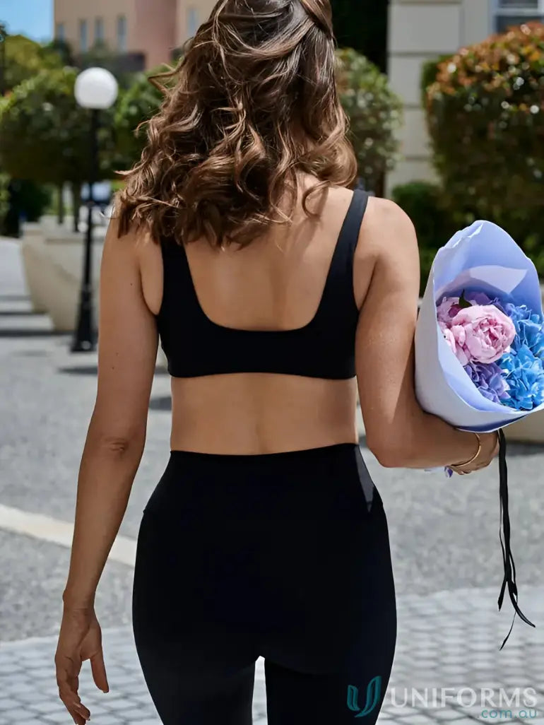 Black athletic crop top with square back cutout and sleek fit perfect for sporty uniforms and work uniforms