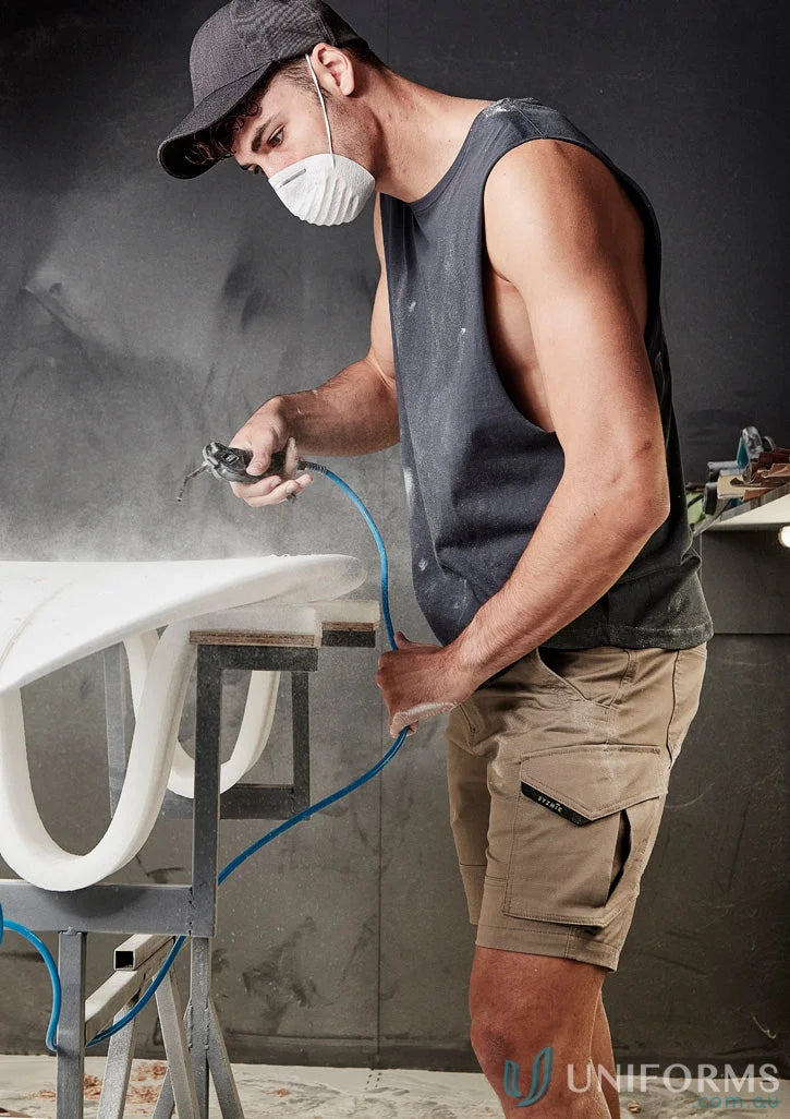 Man spray-painting surfboard wearing Mens Streetworx Sleeveless Tee with drop armholes