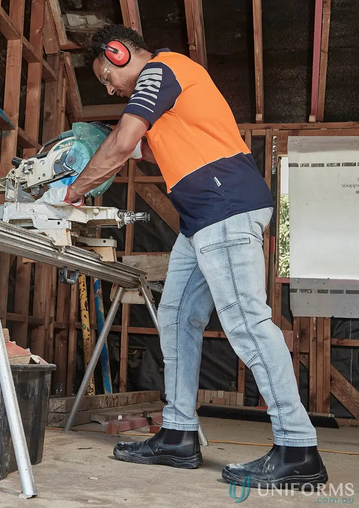 Construction worker using chop saw in streetworx stretch jean for demand performance