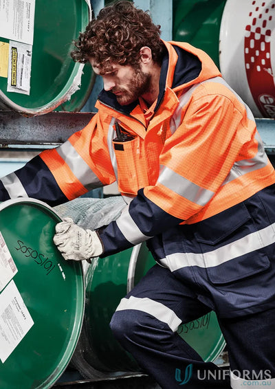 Man wearing Syzmik ZJ900 waterproof jacket, mens orange flame arc rated antistatic gear