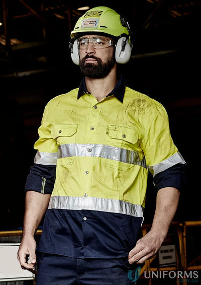 Man in safety gear wearing Syzmik Mens Industrial Long Sleeve Shirt Hoop Taped zw123 for demanding work environments