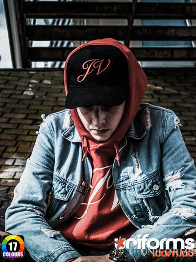 Man in denim jacket and hoodie wearing Traditional Cap, ideal for work uniforms or uniforms