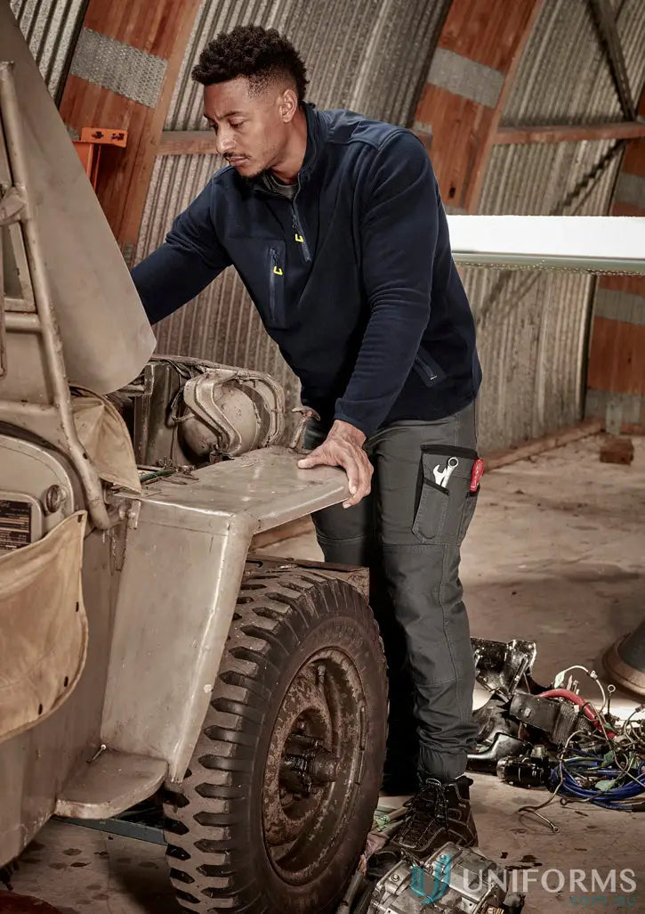 Man in navy zip polar fleece and dark gray work pants, perfect for streetworx lightweight warmth
