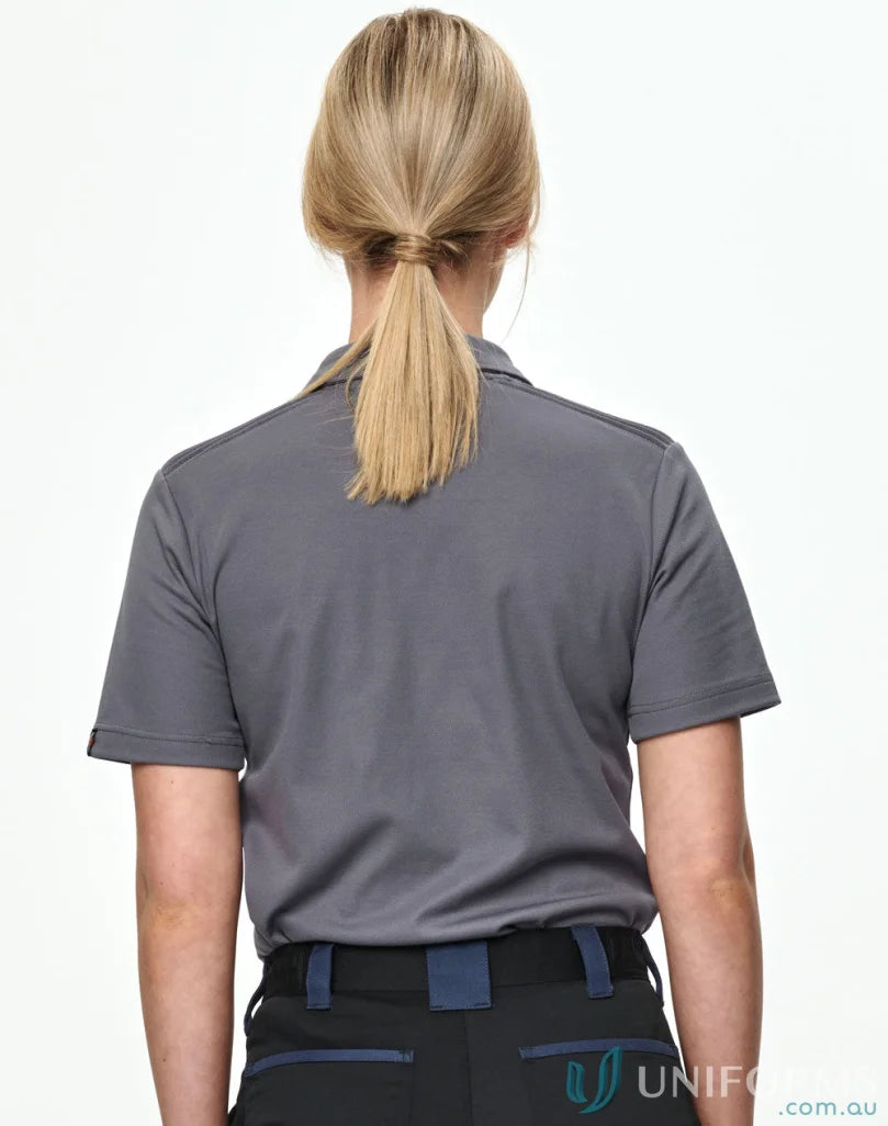 Woman from behind in spirit xstreet unisex short sleeve polo shirt, blonde ponytail