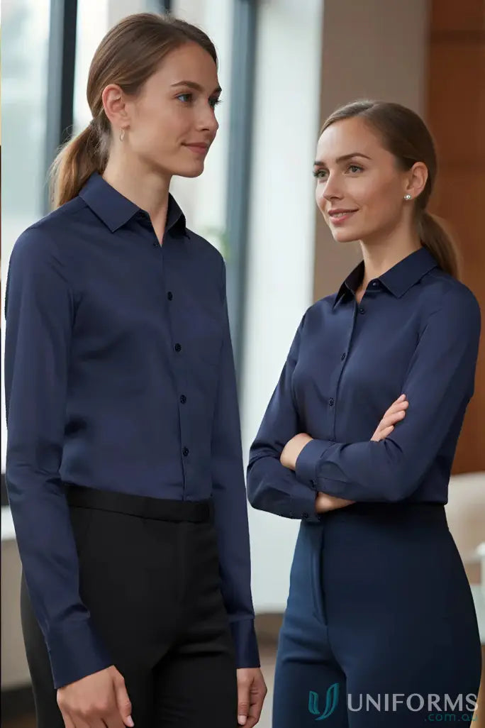 Two women in navy YR Ladies EMB LS Shirts from Monaco Long women’s biz collection